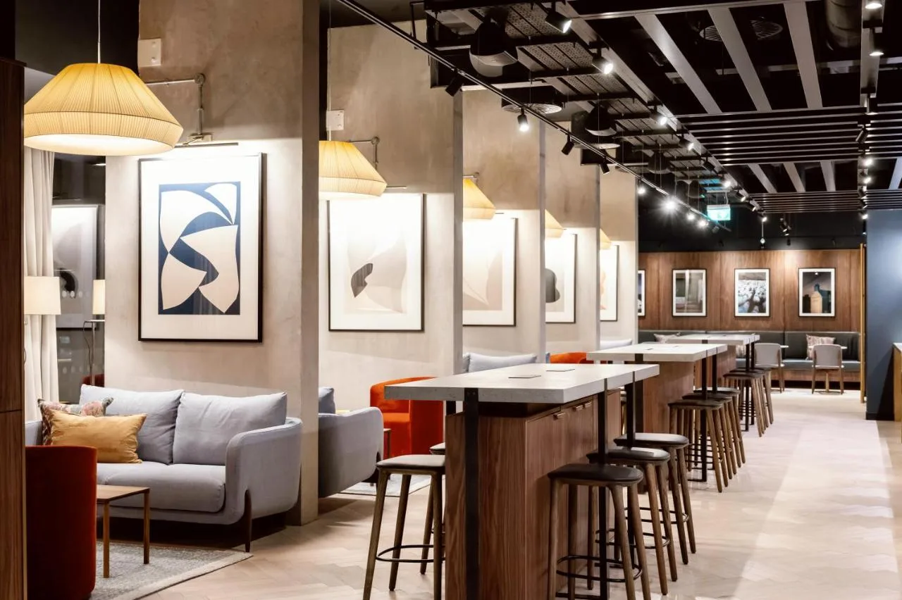 a lobby with a row of bar stools at Wilde Aparthotels Manchester City Centre in Manchester