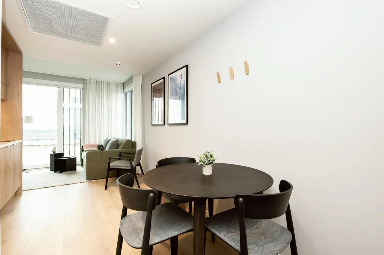 a living room with a dining room table and chairs at Wilde Aparthotels Manchester City Centre in Manchester
