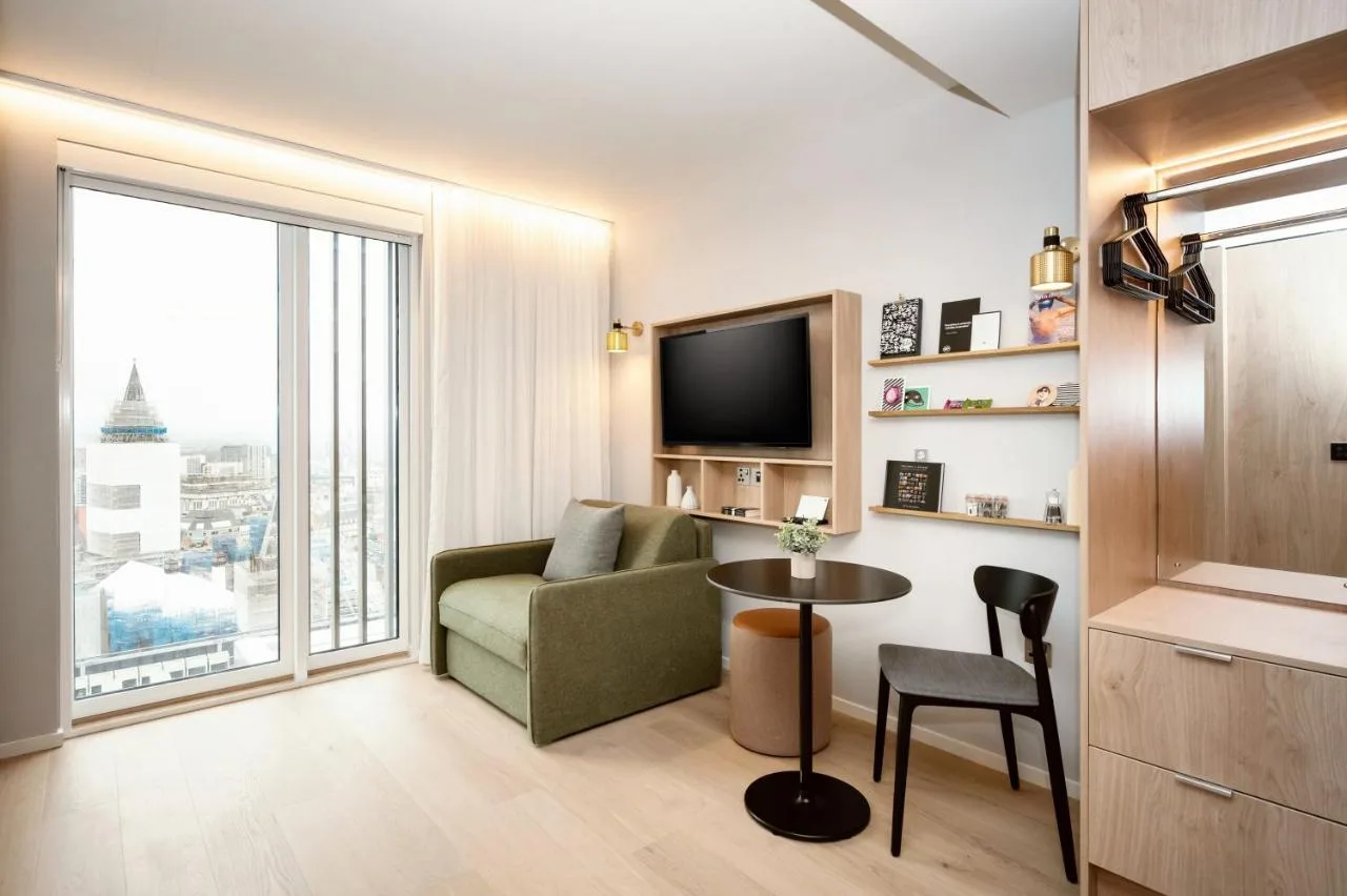 a living room with a couch and a table at Wilde Aparthotels Manchester City Centre in Manchester