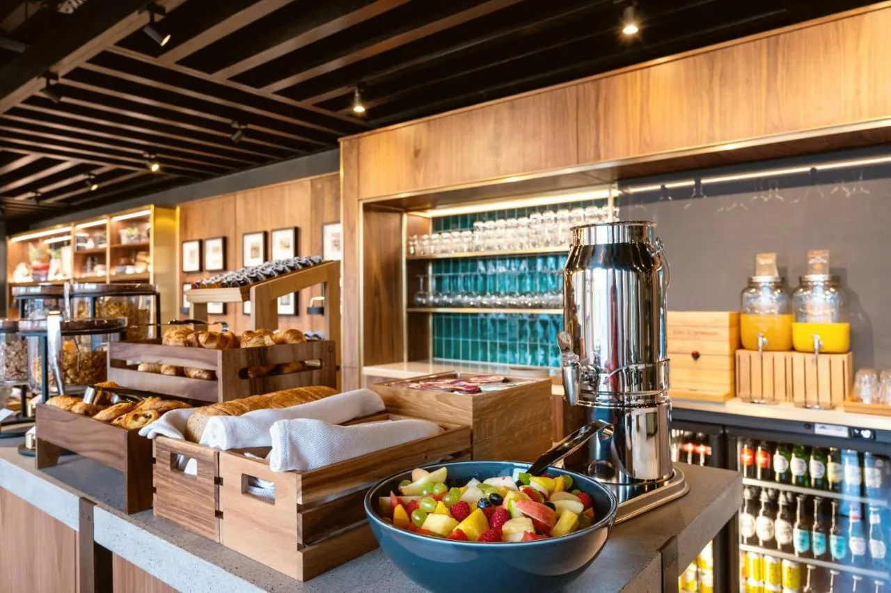 a kitchen with a bowl of fruit on a counter with a juicer at Wilde Aparthotels Manchester City Centre in Manchester